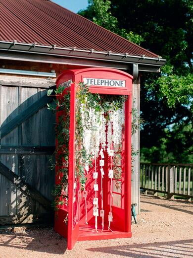 Deckled Edge Escort Cards with Wax Seal in Blush and Gold Inside Telephone Booth Display