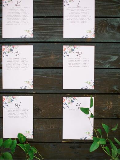 Escort Signs with Bright Florals on Wood Display with Greenery