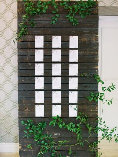 Escort Signs with Bright Floral on Wood Display with Greenery