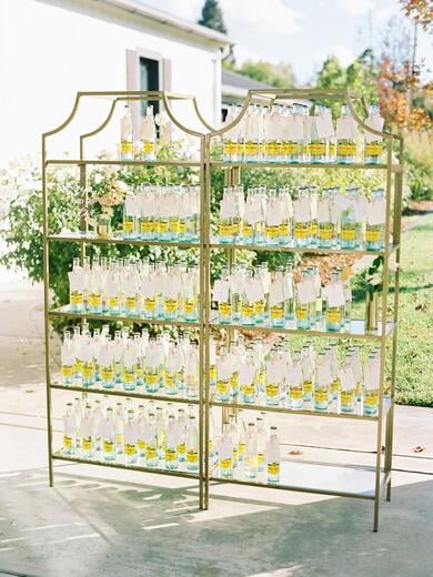 Favor Topo Chico Escort Cards Tied with Blush Ribbon on Gold Shelf