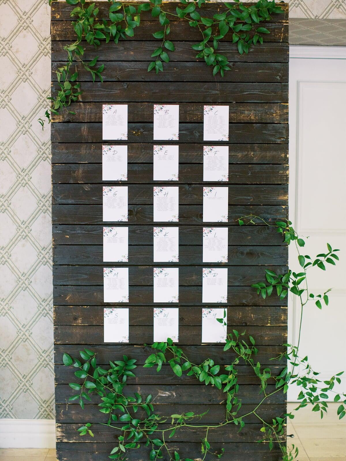 Escort Signs with Bright Floral on Wood Display with Greenery