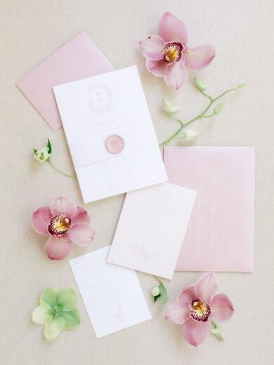 Delicate Floral Wreath Monogrammed Wedding Invitation in Pink Blush with Vellum Band, Wax Seal, RSVP and Guest Addressing