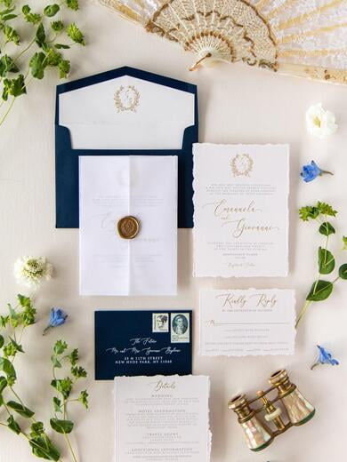 Gold Wax Seal Vellum Jacket Enclosed Wedding Invitation in Navy with Deckled Edges and Wreath Monogram on Pale Pink Paper