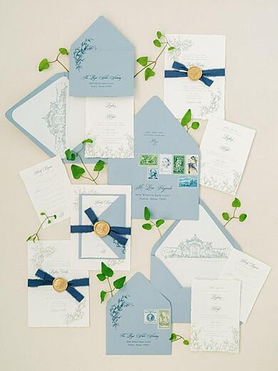 The Olana Dallas Texas Deckled Edge Invitation with Floral in Dusty Blue, Green and Gold