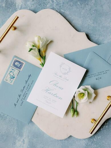 Save the Date with Delicate Greenery Monogram Crest in Dusty Blue