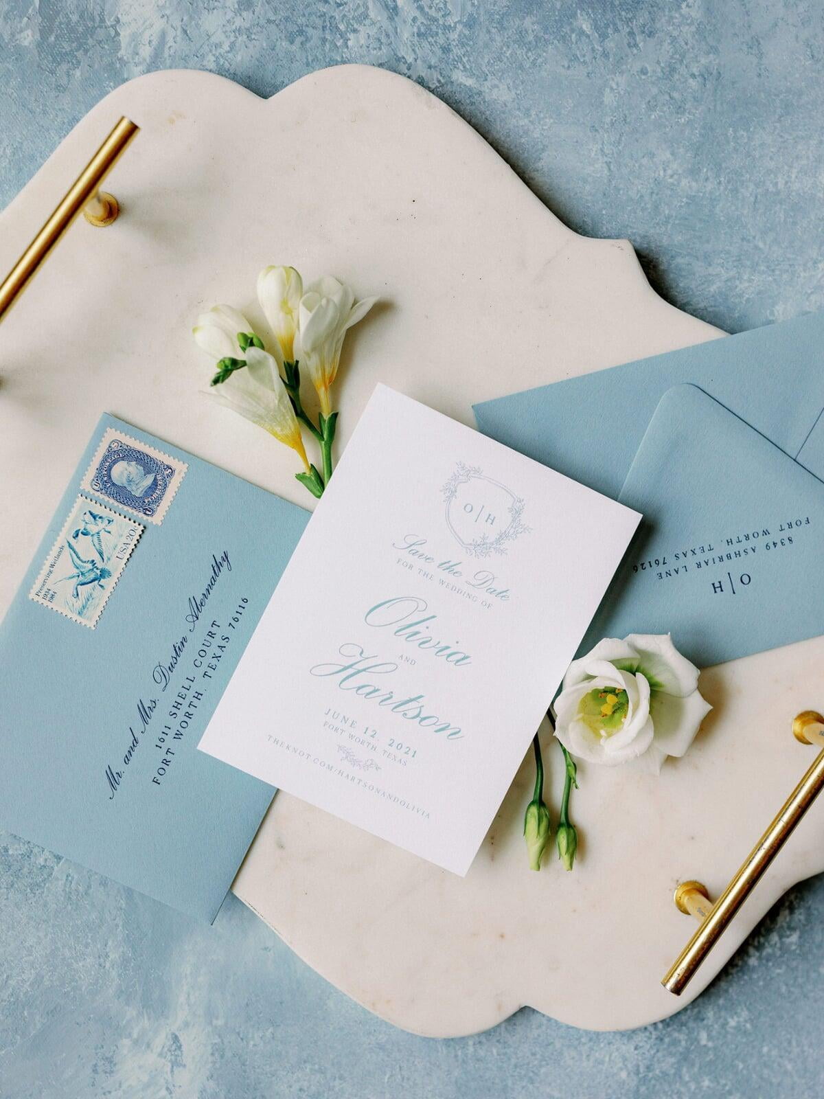 Save the Date with Delicate Greenery Monogram Crest in Dusty Blue