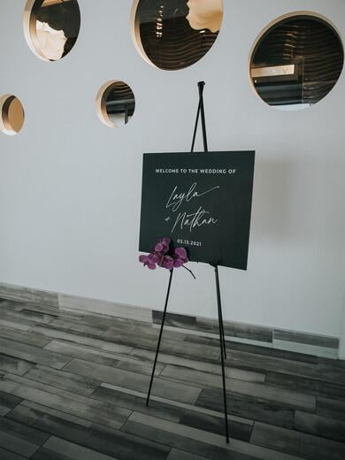 Modern Black Welcome Sign with White Ink and Orchids